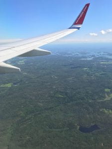 A picture of the plane wing over the Helsinki landscape