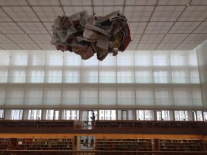 A large open room in the State Library with a paper sculpture hanging down from the ceiling