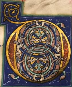 illuminated initial showing a group of lions on a background of intertwined blue vines