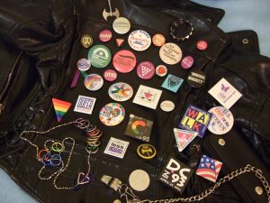 a black vest covered with many buttons supporting LGTBQ+ causes