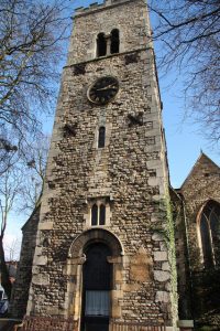 photo of a stone church tower against a blue sky